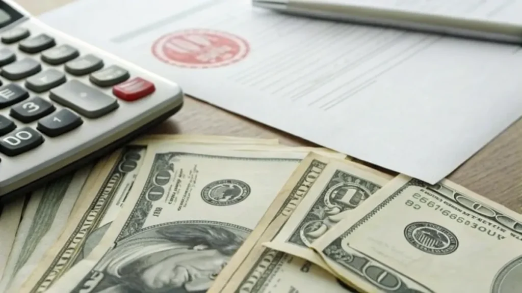 Professionals reviewing business insurance costs and premium statements at a desk.