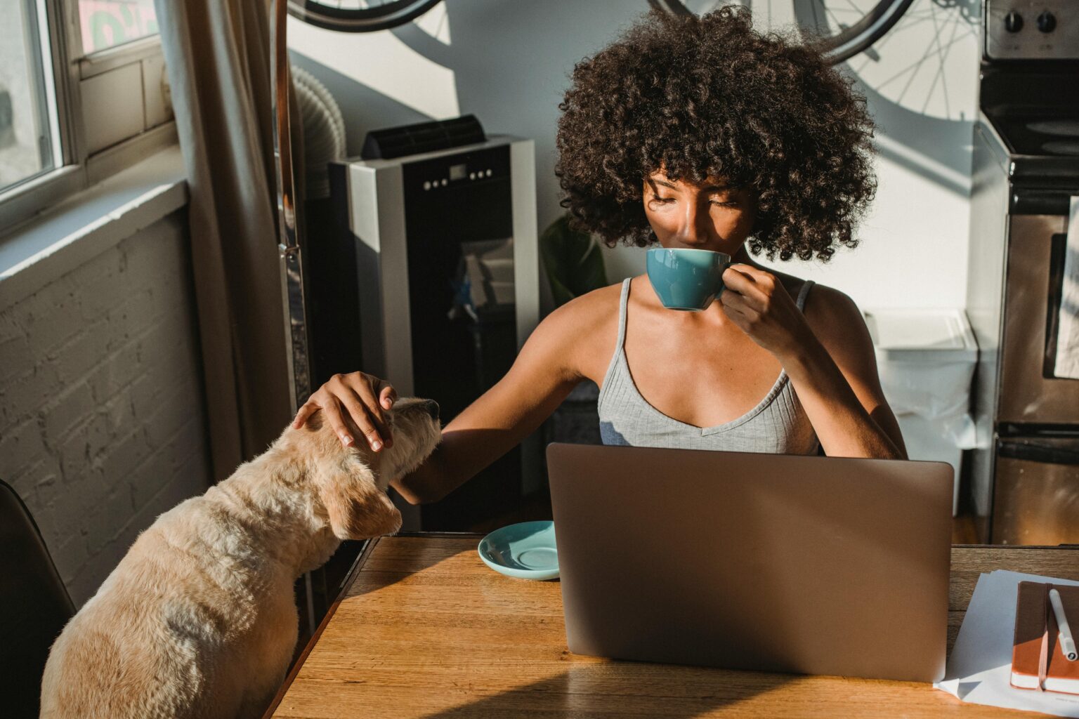 Self employed professional at home with a laptop and coffee, highlighting the need for insurance for self employed professionals.